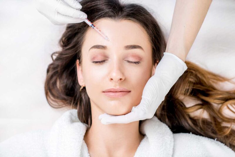 woman having a brow injection procedure performed